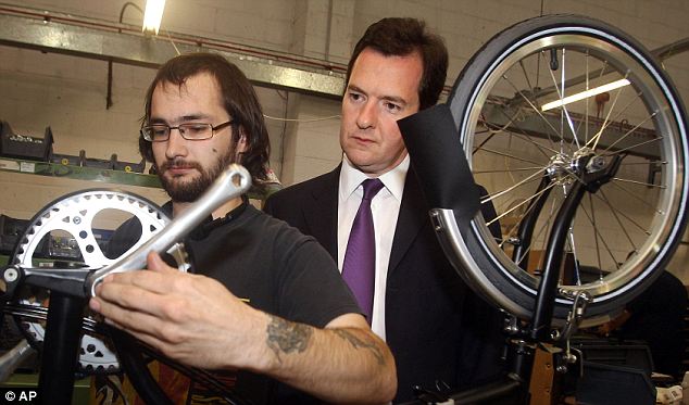 George at a bicycle shop learning how to make his own bike.